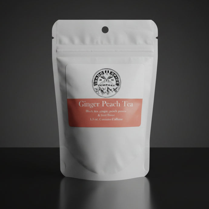 Tea package labeled 'Ginger Peach Tea' on a wooden surface
