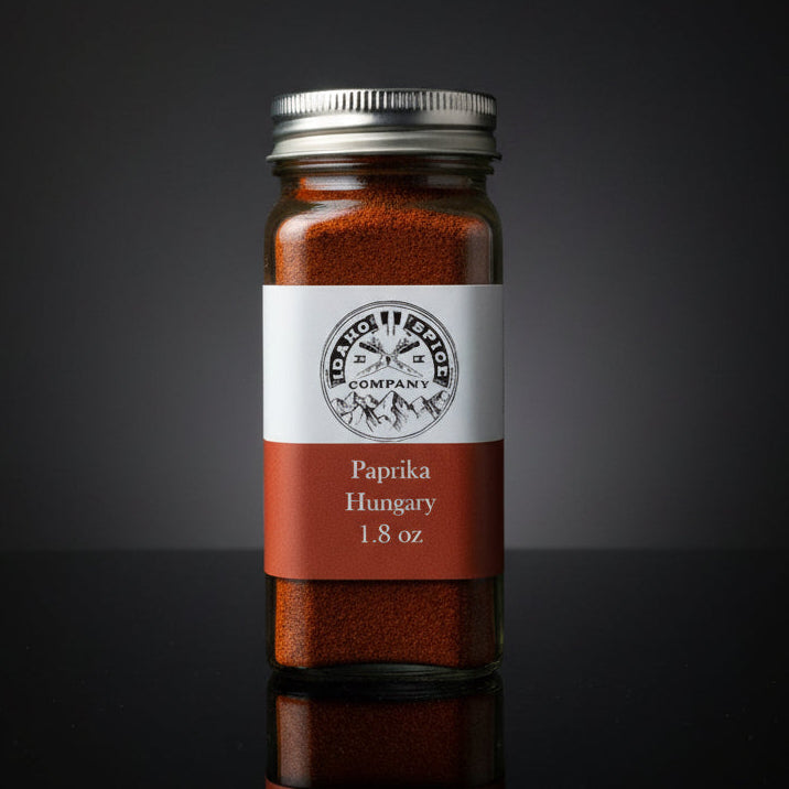 Jar of paprika with a label on a wooden surface