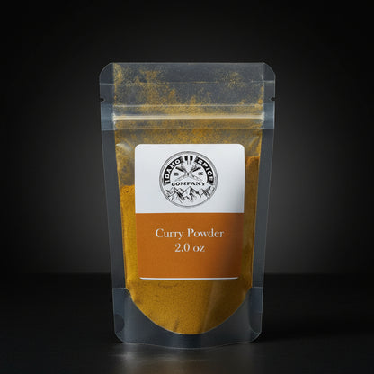 Package of curry powder with a label on a wooden surface
