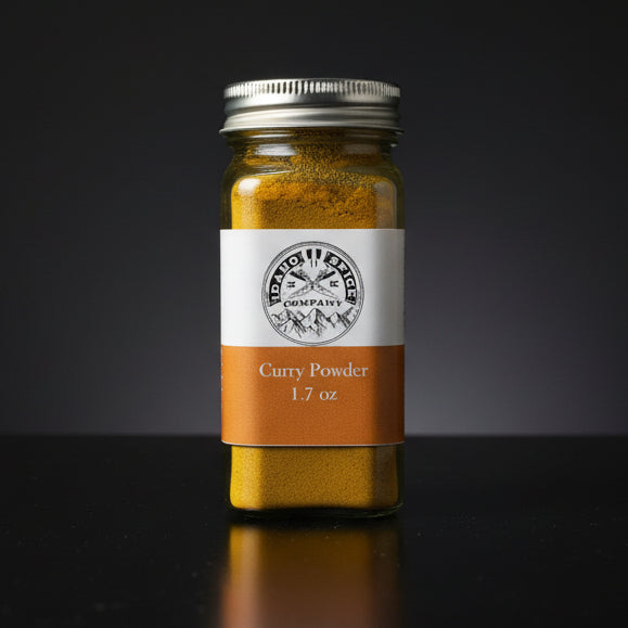 Jar of curry powder with a label on a wooden surface