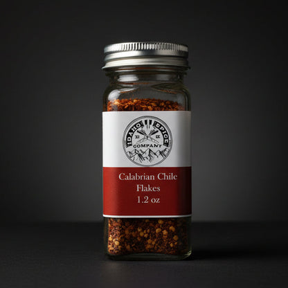 Jar of Calabrian Chile Flakes with a label on a black background