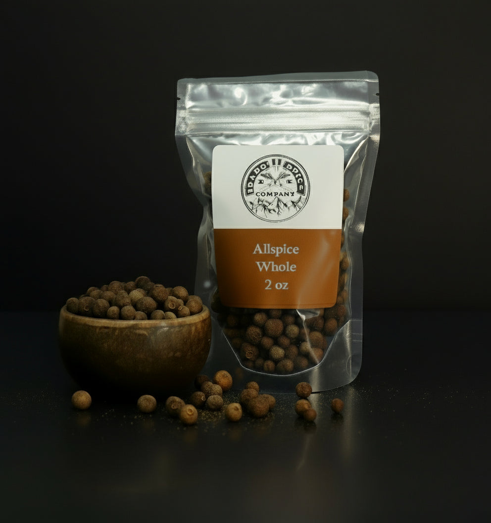 Packaged allspice whole with a wooden bowl on a dark background