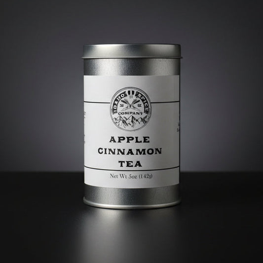 Silver canister of Apple Cinnamon Tea on a black background