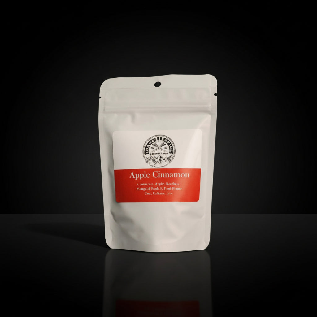 White tea package with 'Apple Cinnamon' flavor label on a dark background