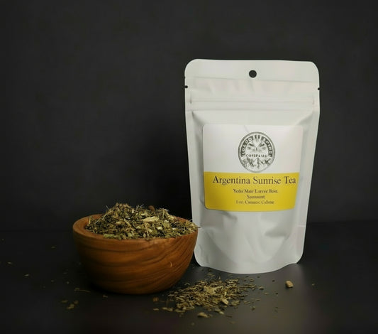 Tea packaging with a wooden bowl of tea leaves on a dark background