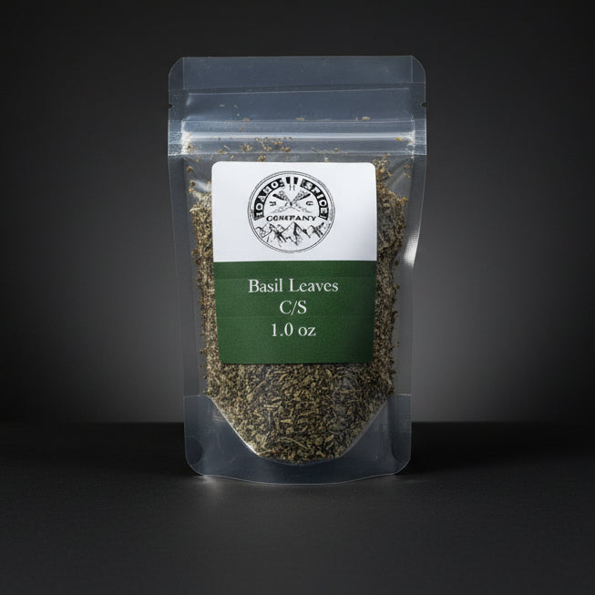 Packaged basil leaves on a wooden surface with a dark background