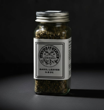 Jar of basil leaves with a label on a dark background