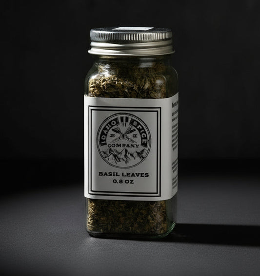 Jar of basil leaves with a label on a dark background