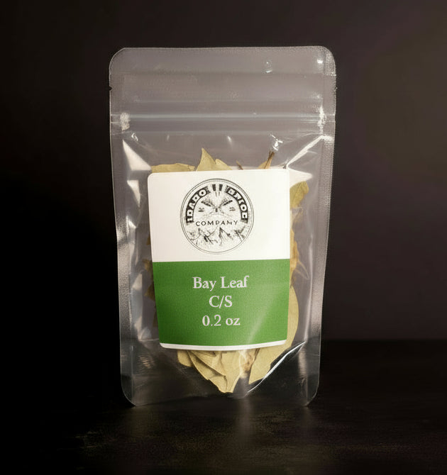 Clear packaging of bay leaf with a label on a dark background