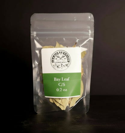 Clear packaging of bay leaf with a label on a dark background