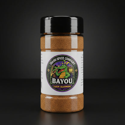Spice jar labeled 'Bayou Cajun Seasoning' from Idaho Spice Company on a dark background