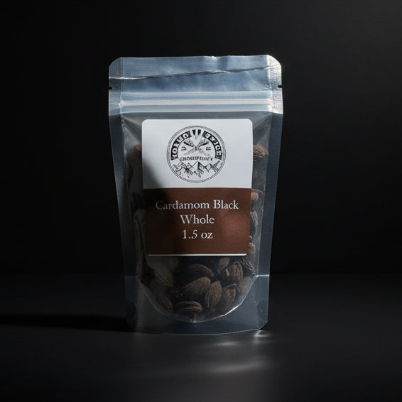 Packaged cardamom black whole on a dark background
