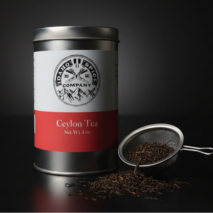 Tea canister with a red label and a small scoop of tea leaves on a dark background