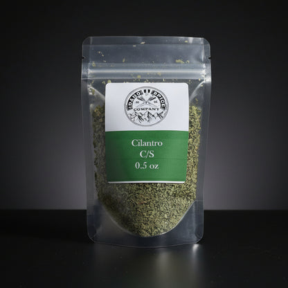 Packaged cilantro with a label on a black background