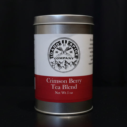 Silver tin labeled 'Idaho Spice Company Crimson Berry Tea Blend' on a black background
