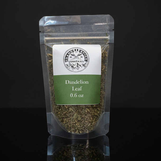 Packaged dandelion leaf on a wooden surface with a dark background