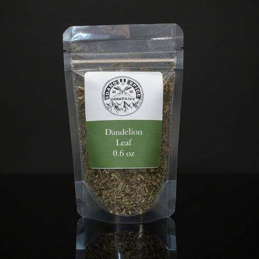 Packaged dandelion leaf on a wooden surface with a dark background