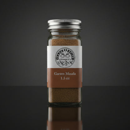 Jar of Garam Masala with a label on a dark background