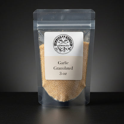 Packaged garlic granules with a label on a dark background