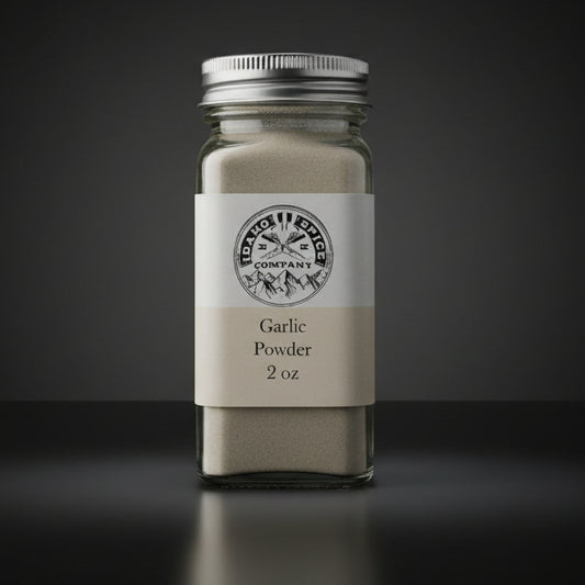 Jar of garlic powder on a wooden surface with a dark fabric background