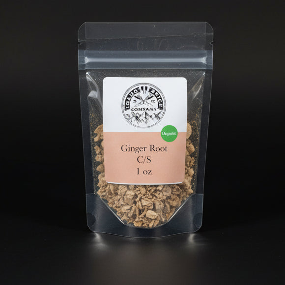 Packaged ginger root on a black background with a visible brand label.
