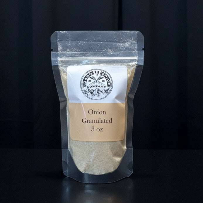 Pouch of onion granules with a label on a wooden surface