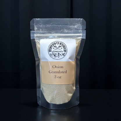 Pouch of onion granules with a label on a wooden surface