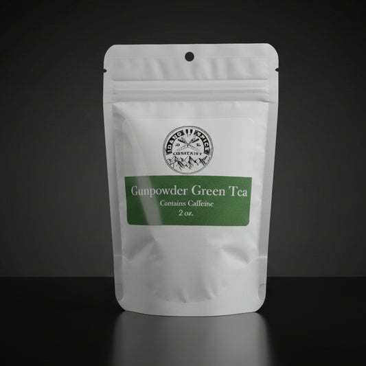 White package of Gunpowder Green Tea with a green label on a wooden surface.