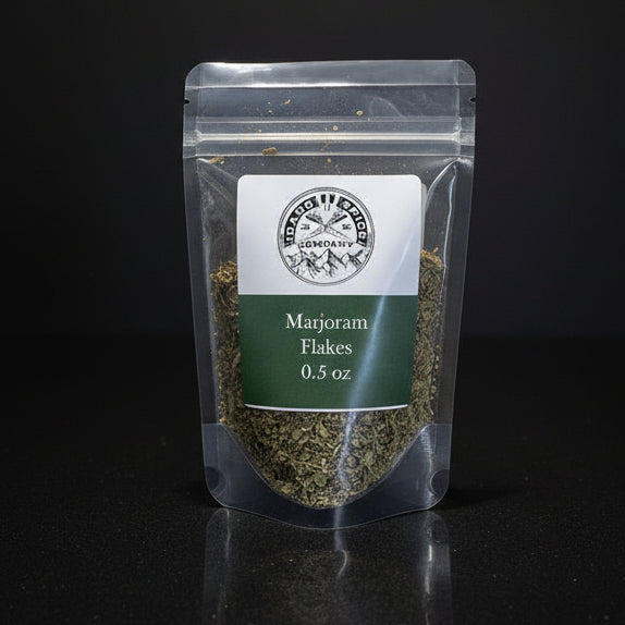 Packaged marjoram flakes with a label on a black background