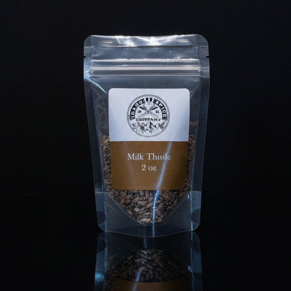 Packaged milk thistle seeds with a label on a black background