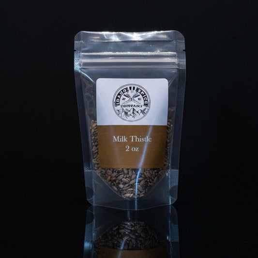 Packaged milk thistle seeds with a label on a black background