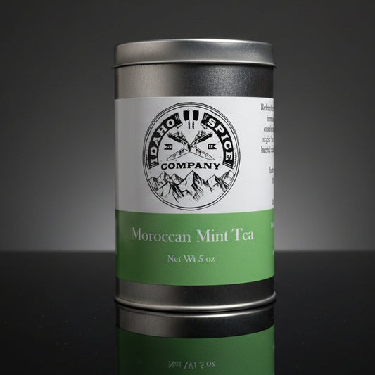 Metal canister of Moroccan Mint Tea with a label on a dark surface
