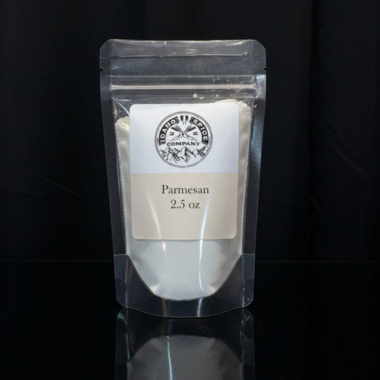 Packaged Parmesan cheese with a label on a black background
