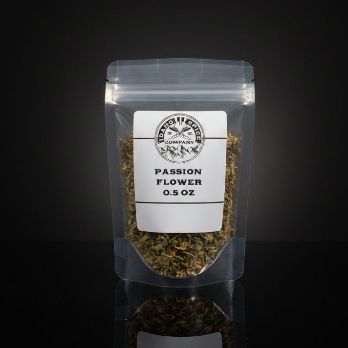 Container of passion flower on a wooden surface with a black background
