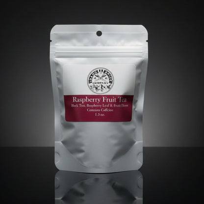 Tea package labeled 'Raspberry Fruit Tea' on a reflective surface with a dark background