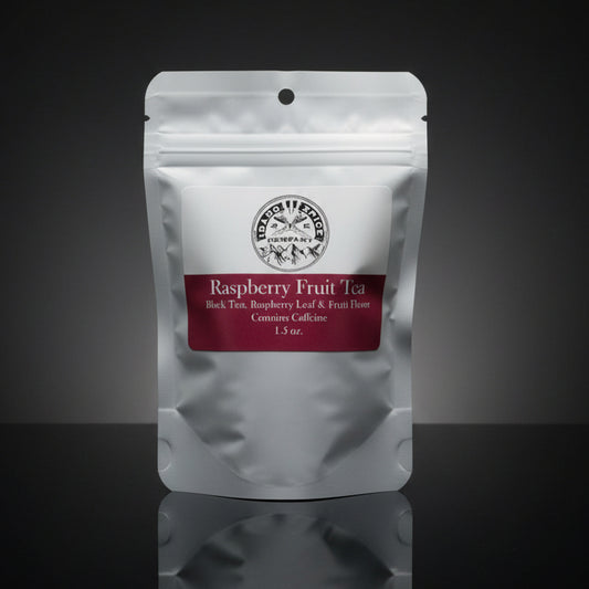 Tea package labeled 'Raspberry Fruit Tea' on a reflective surface with a dark background