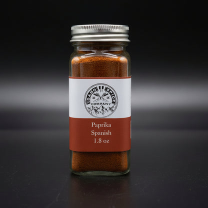 Jar of Spanish paprika with a label on a dark background