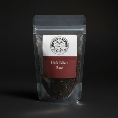 Clear packaging of Urfa Biber pepper with a label on a black background