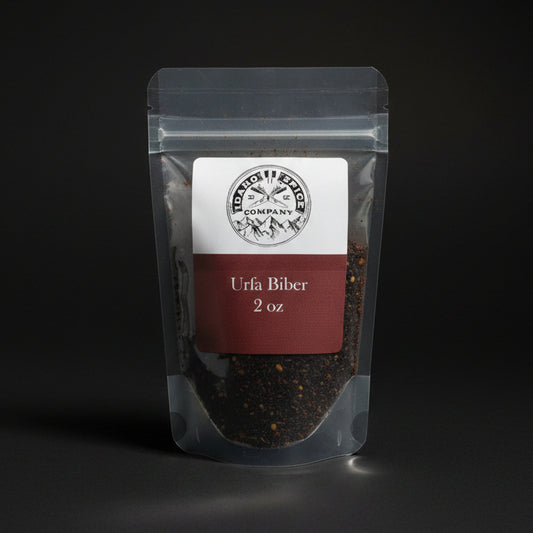 Clear packaging of Urfa Biber pepper with a label on a black background